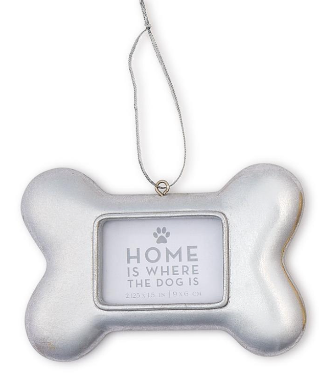 Silver dog bone frame with silver string with statement "Home is where the dog is" in window.