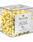 A clear square plastic container filled with Popinsanity Sweet & Salty artisanal popcorn, with a white front label and gold branding, photographed on a white background.
