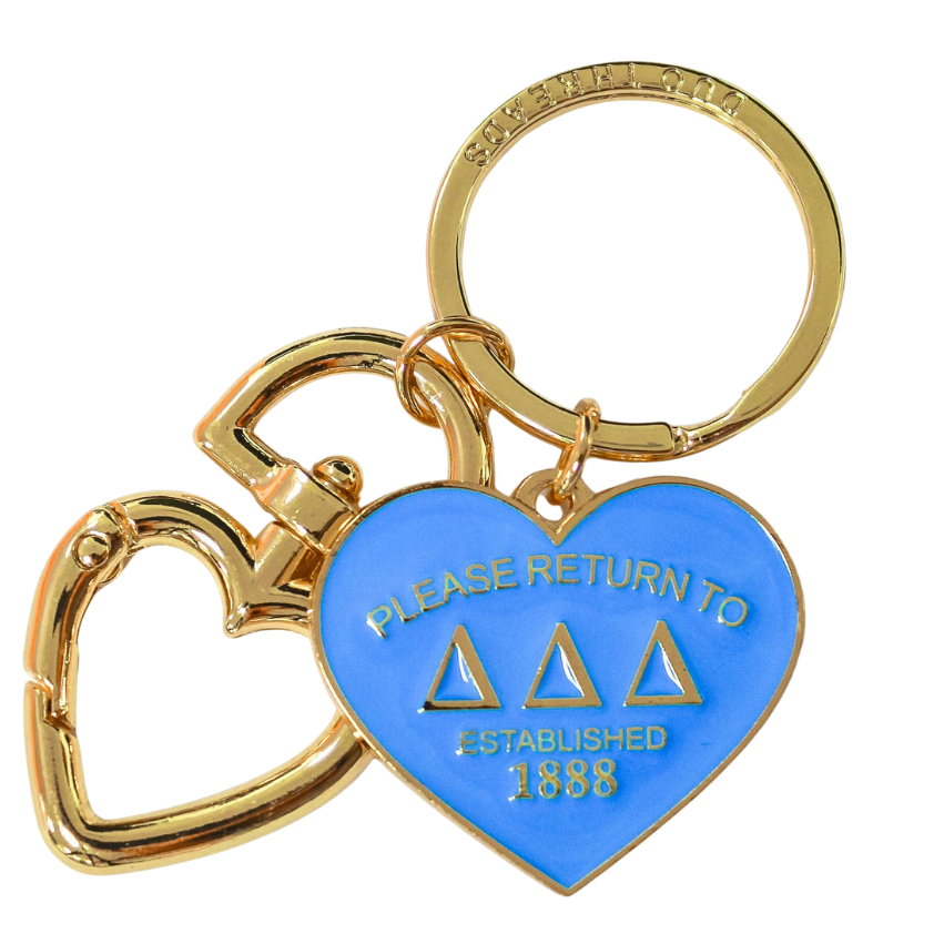 Gold and blue keychain with heart design on a white background