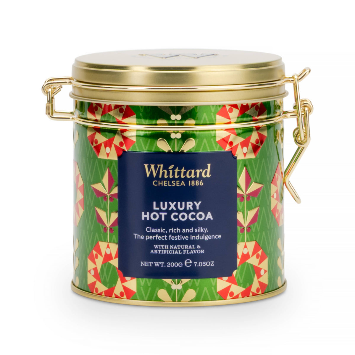 A cylindrical metal tin of Whittard Luxury Hot Cocoa with a gold lid and handles, featuring a green patterned label with red and yellow motifs and a dark blue central label.